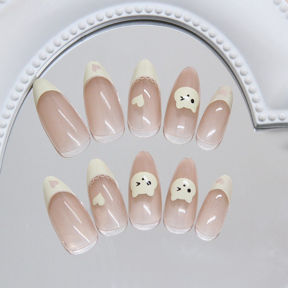 French Tip & Heart Press-On Nails, Medium Almond on hand